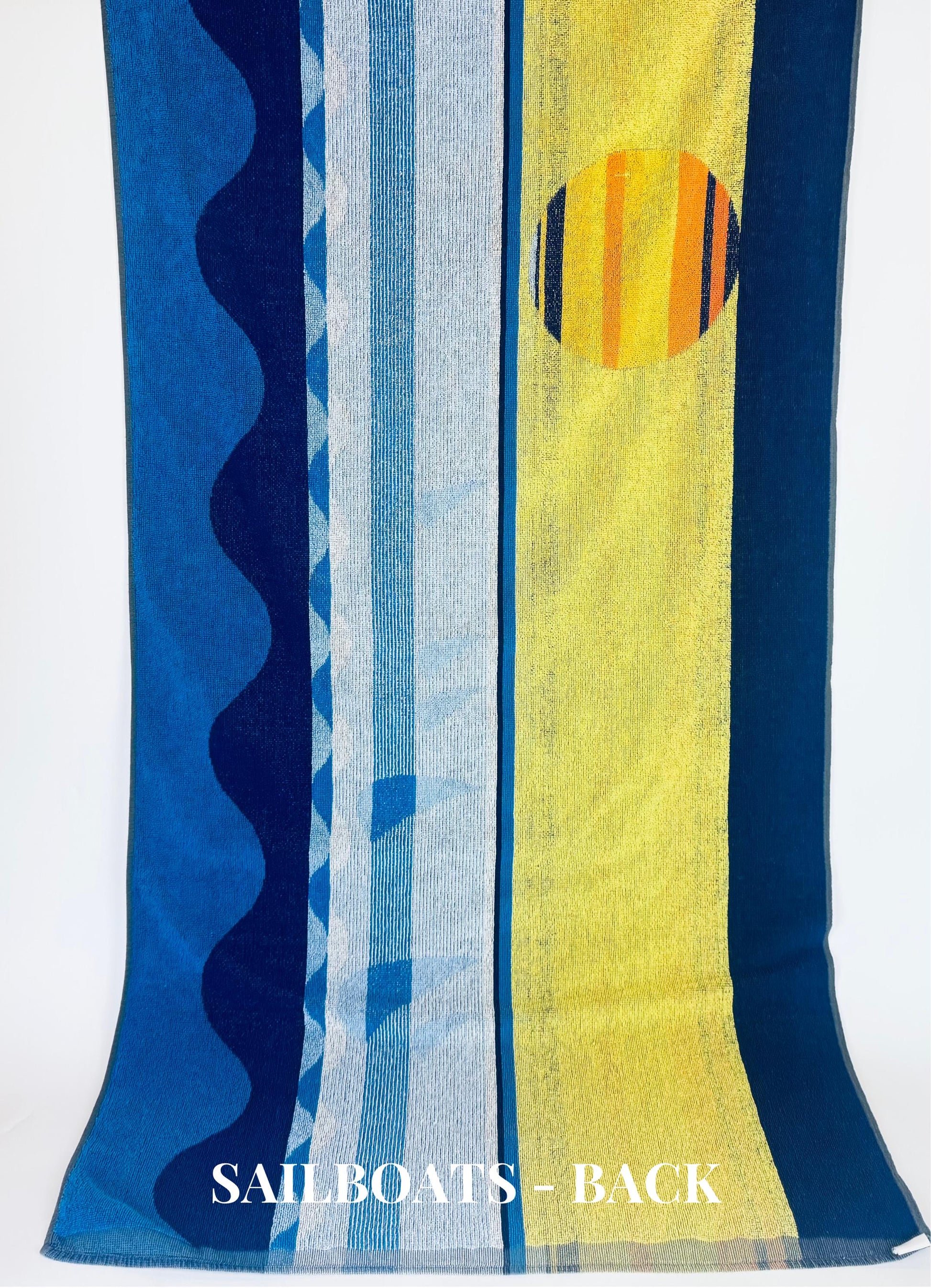 Colorful towel with abstract patterns and 'SAILBOATS - BACK' text on a white background
