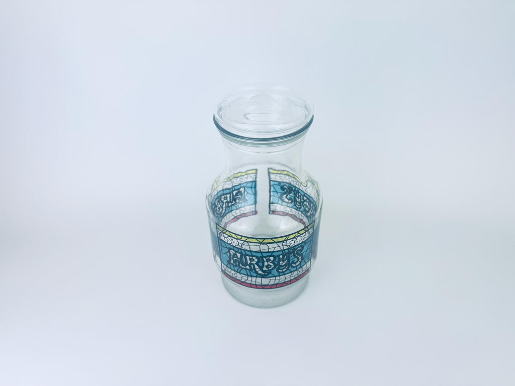 Glass jar with decorative label on a white background