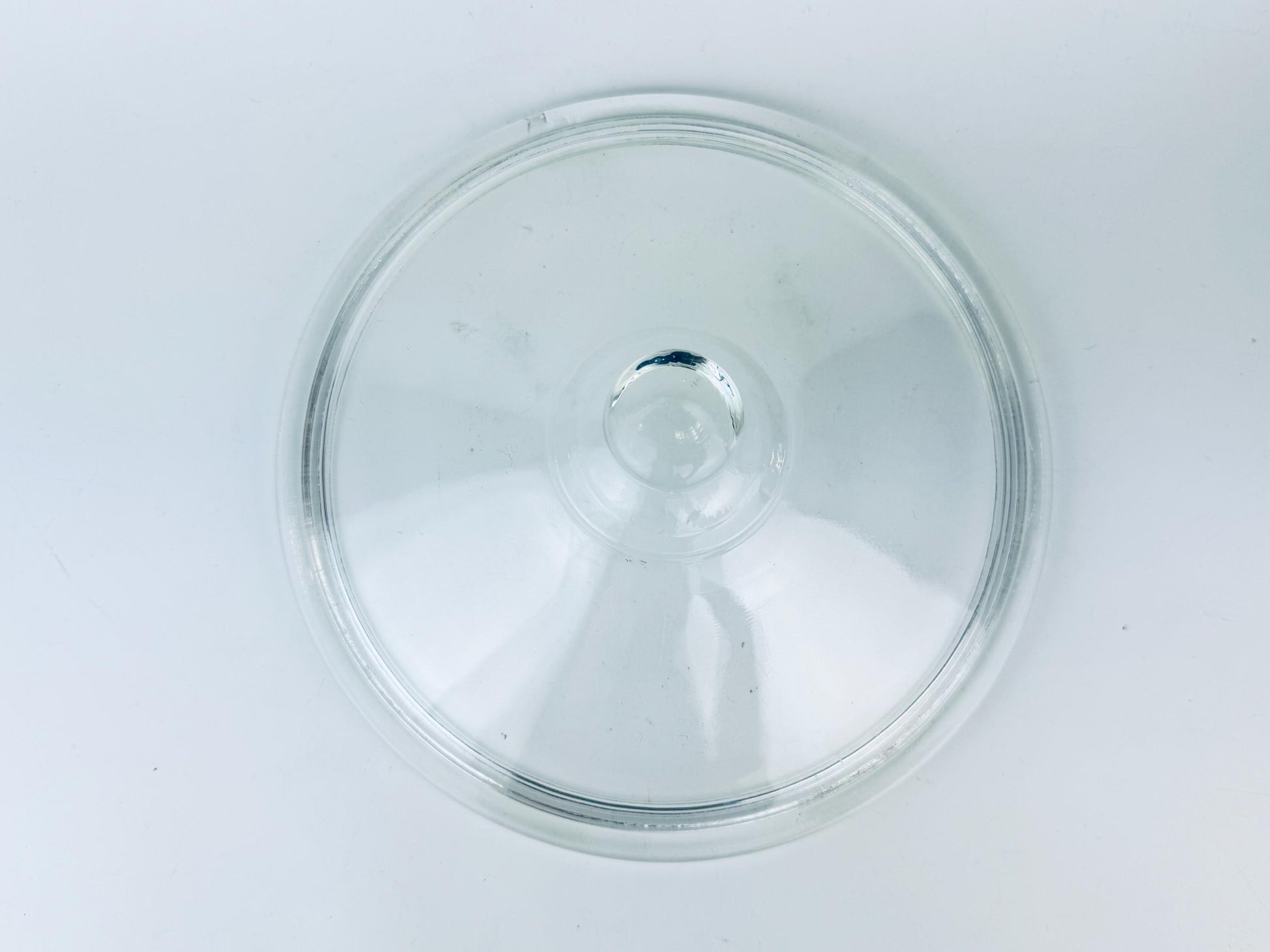 Clear glass lid on a white background