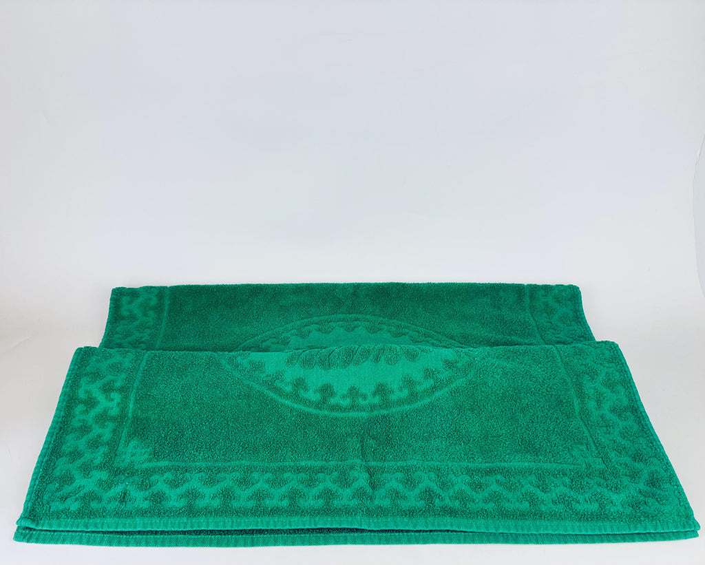 Green towel with a pattern on a white background