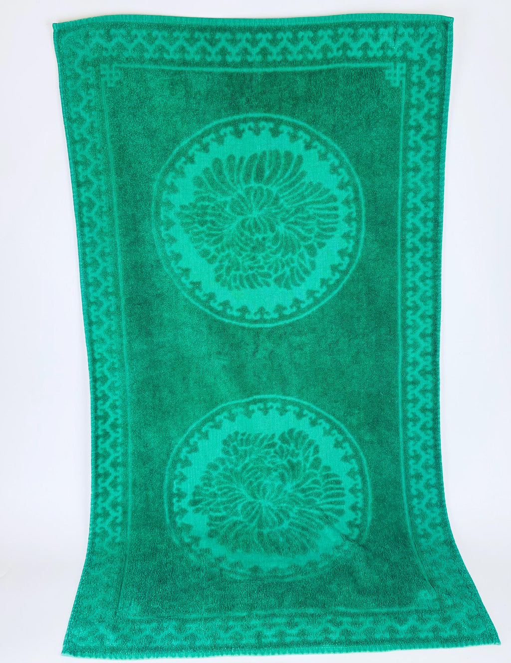 Green towel with circular patterns on a white background