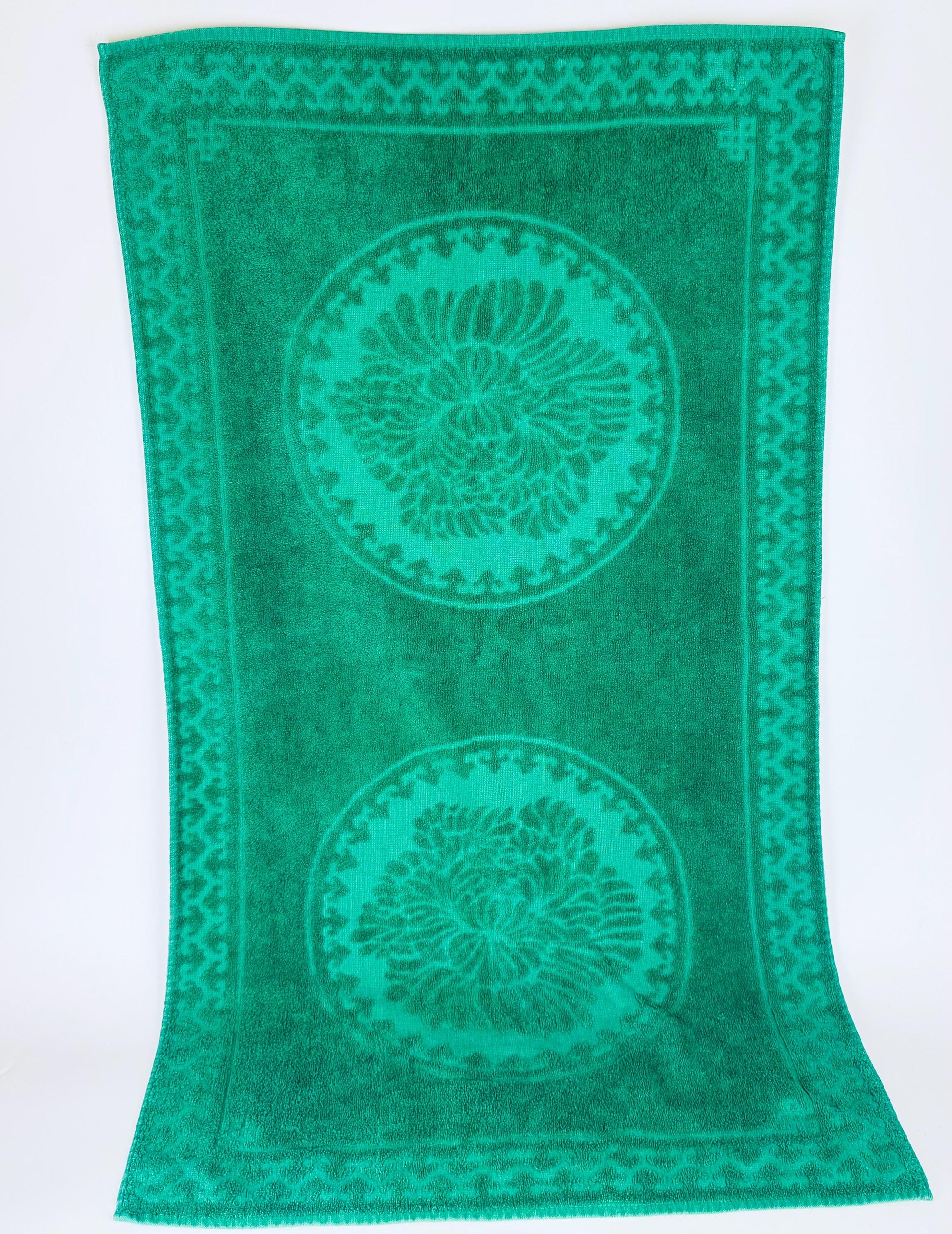 Green towel with circular patterns on a white background