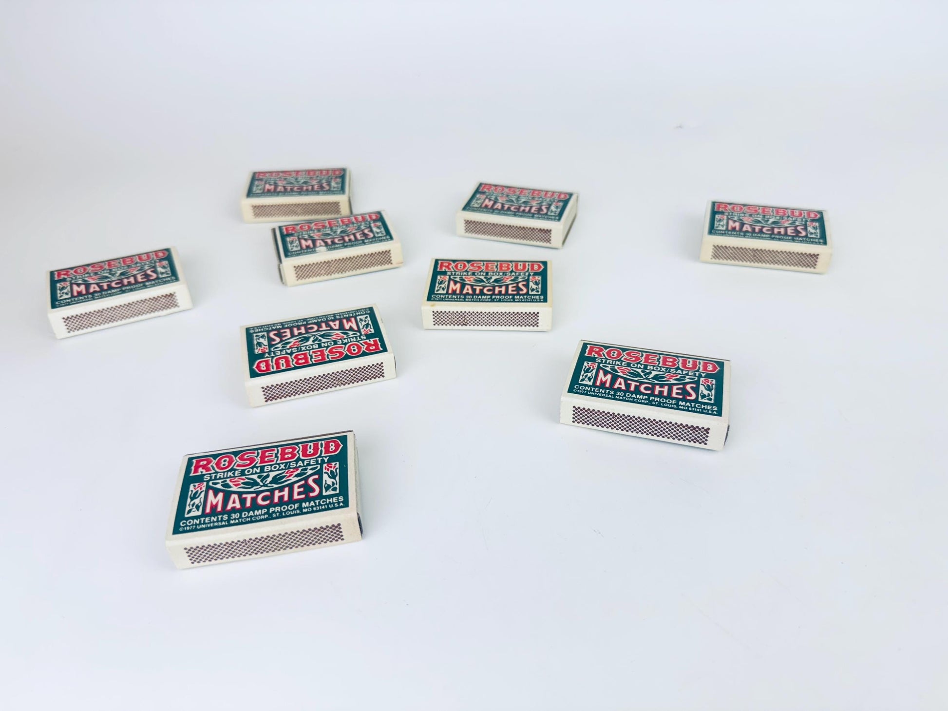 Multiple boxes of Rogerbud matches arranged on a white background