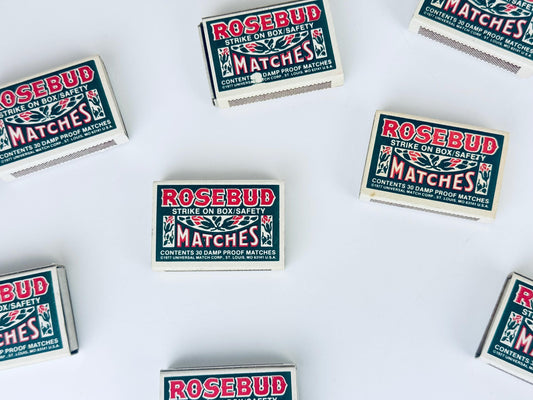 Multiple boxes of Rosebud matches on a white background