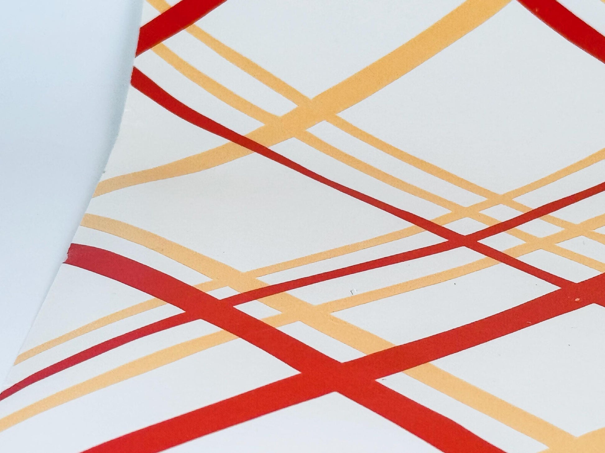 Geometric pattern with red and yellow lines on a white background