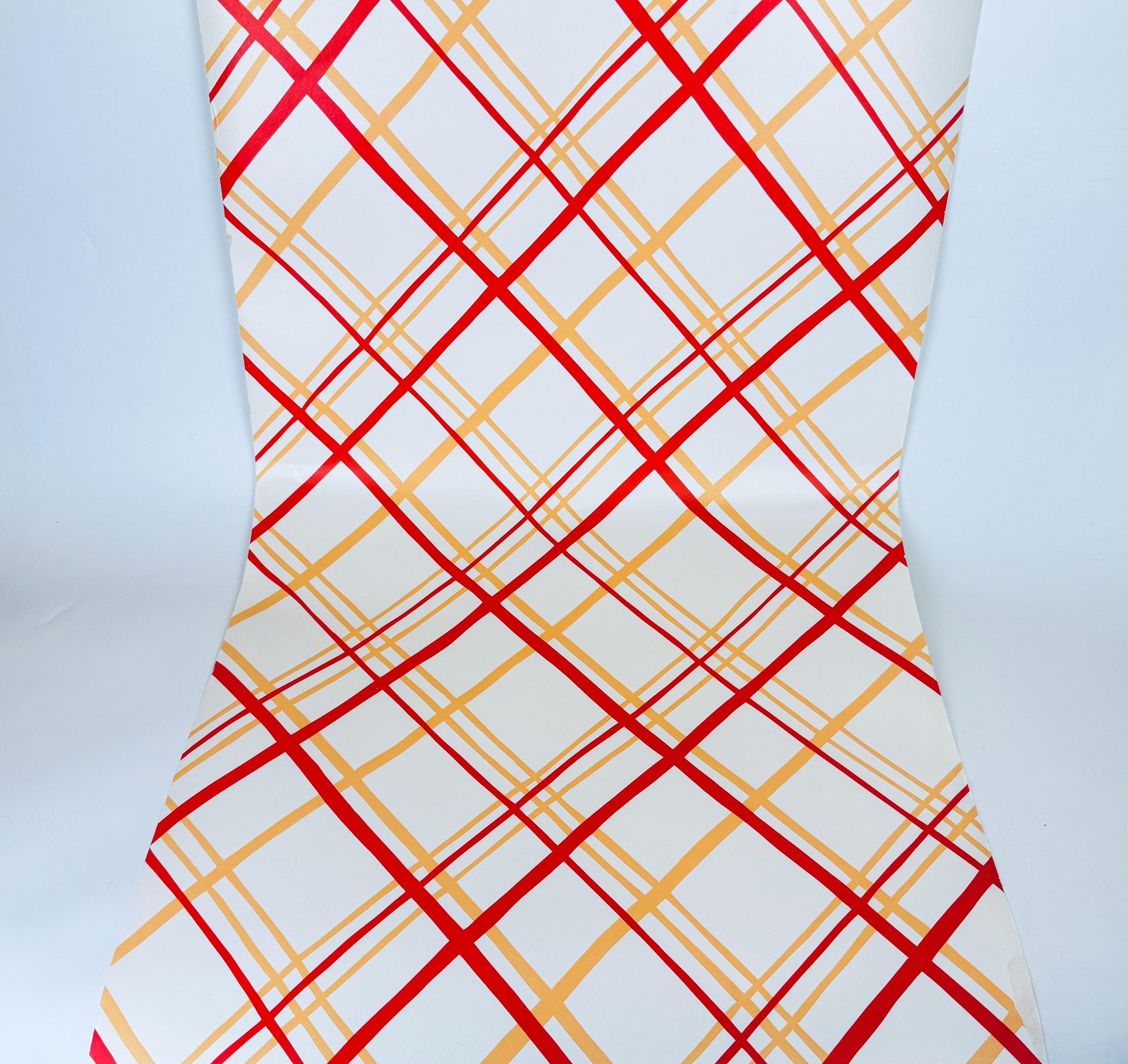 Wallpaper with red and yellow plaid pattern on a white background