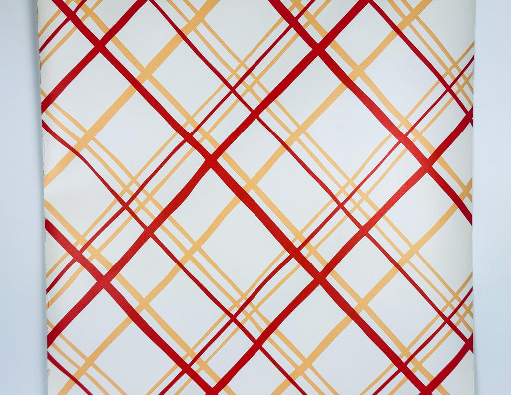 Patterned paper with red and gold geometric design on a white background