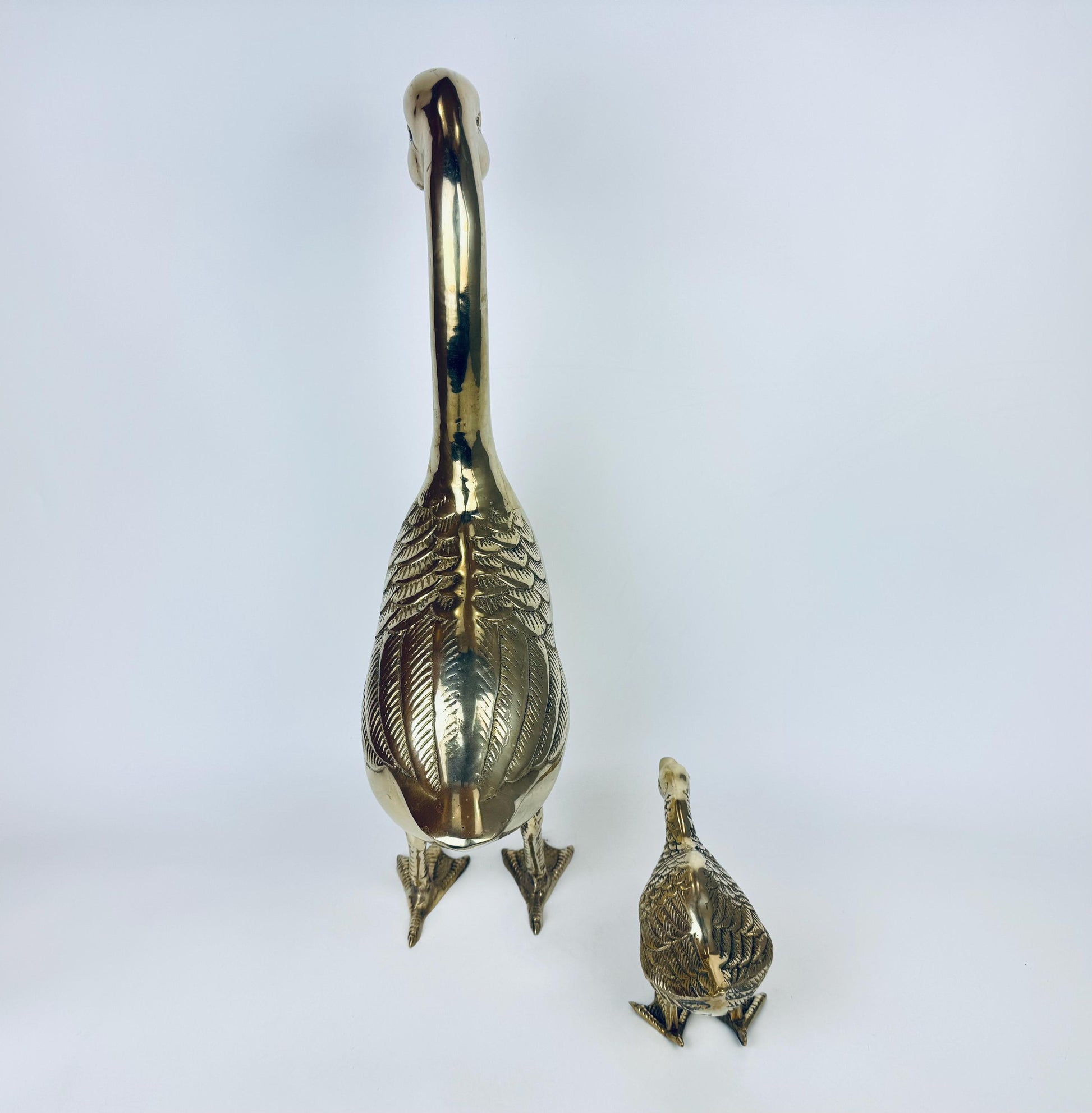 Gold goose-shaped object on a white background
