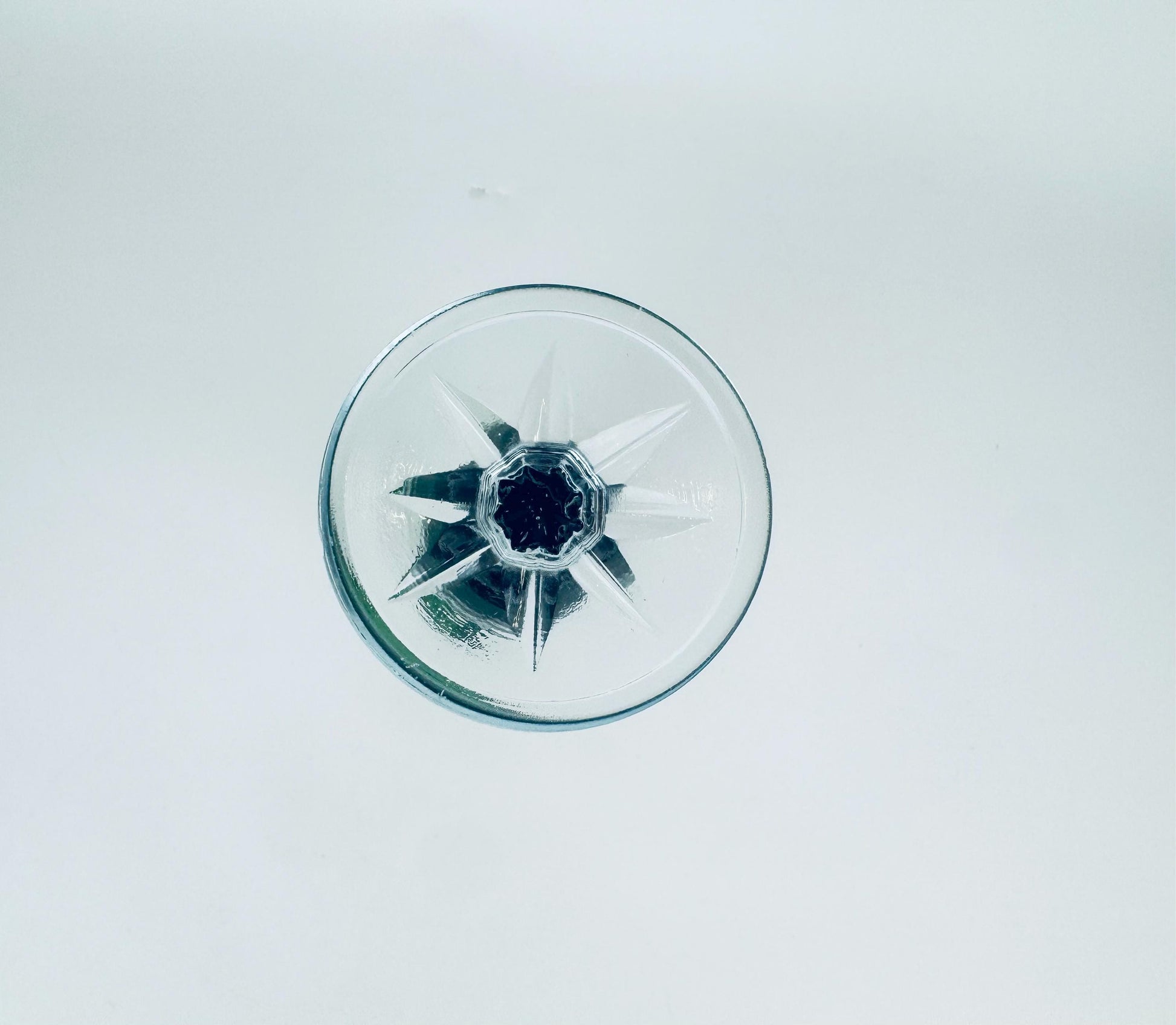 Clear plastic component with star-shaped design on a white background