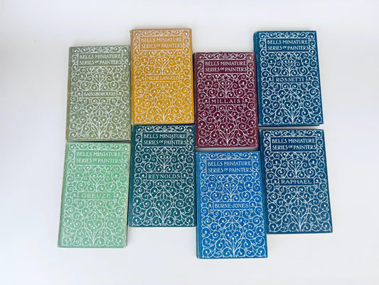 Set of nine books with decorative covers on a white background
