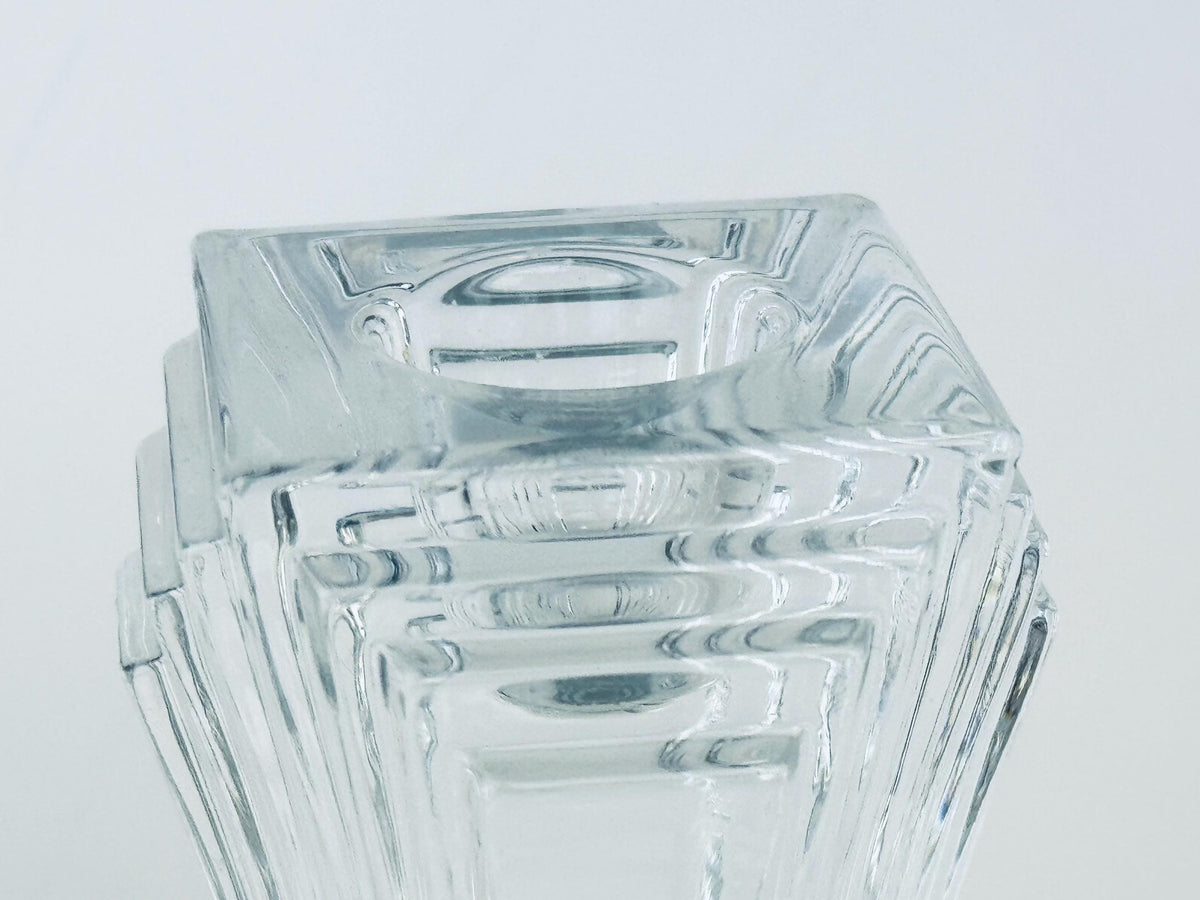 Stack of clear glass square bowls on a light gray background