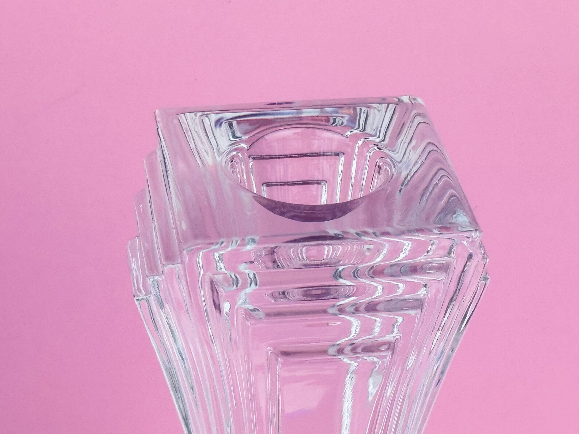Clear glass vase on a pink background