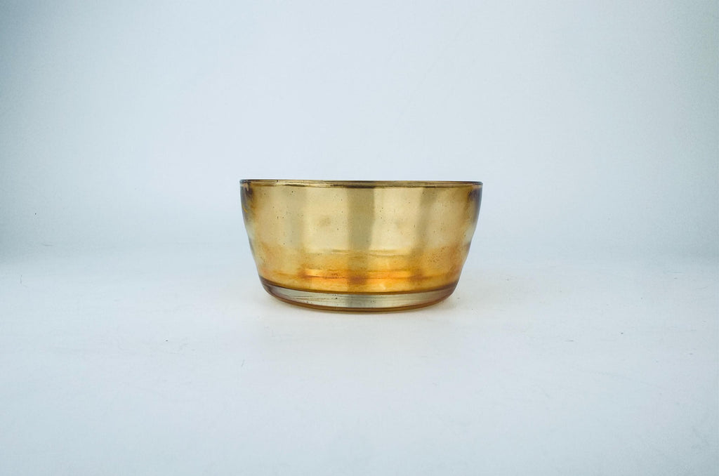Amber glass bowl on a light gray background