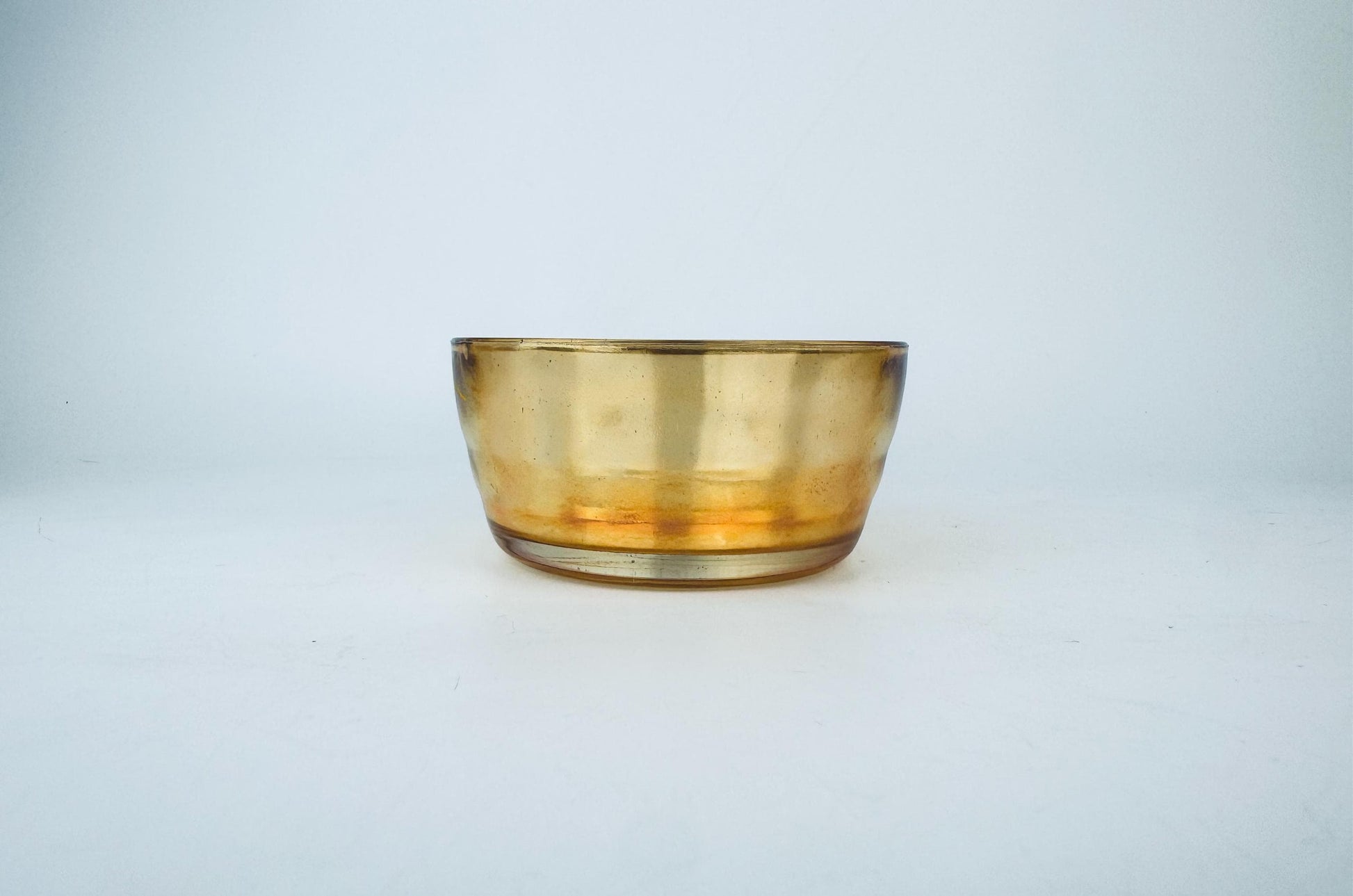 Amber glass bowl on a light gray background