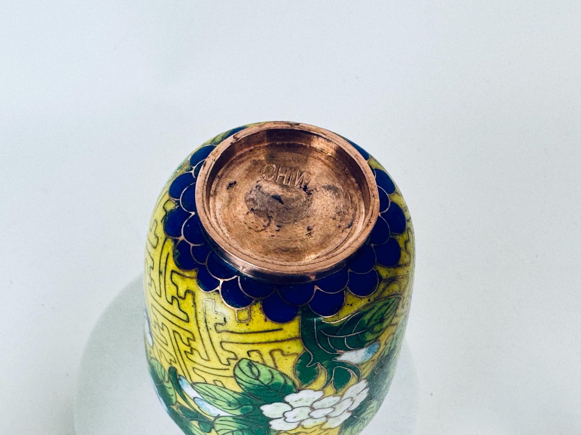 Decorative ceramic vase with intricate designs on a white background