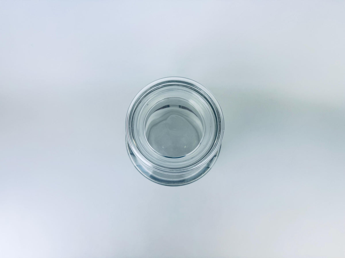 Clear glass jar on a light gray background