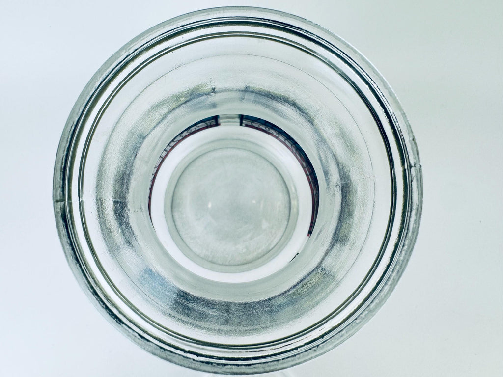 Clear glass pitcher on a light gray background