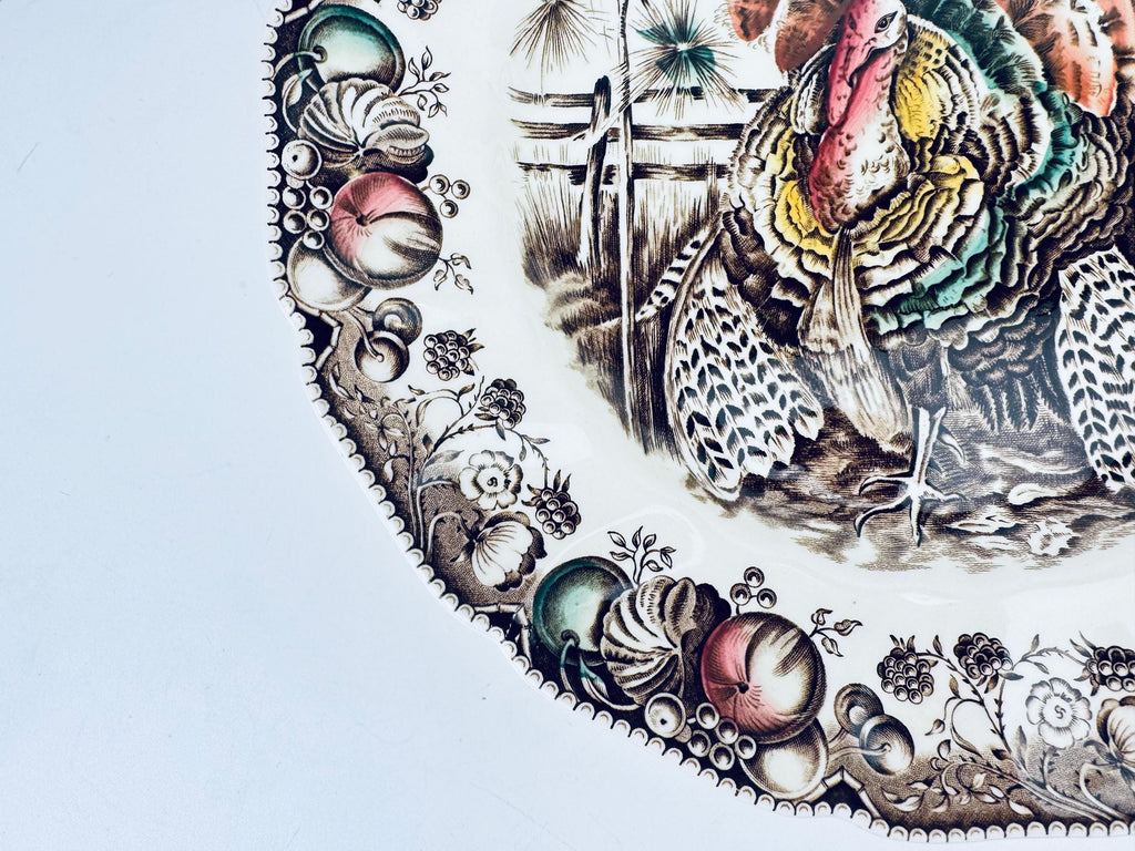 Decorative plate with a turkey and fruit design on a white background