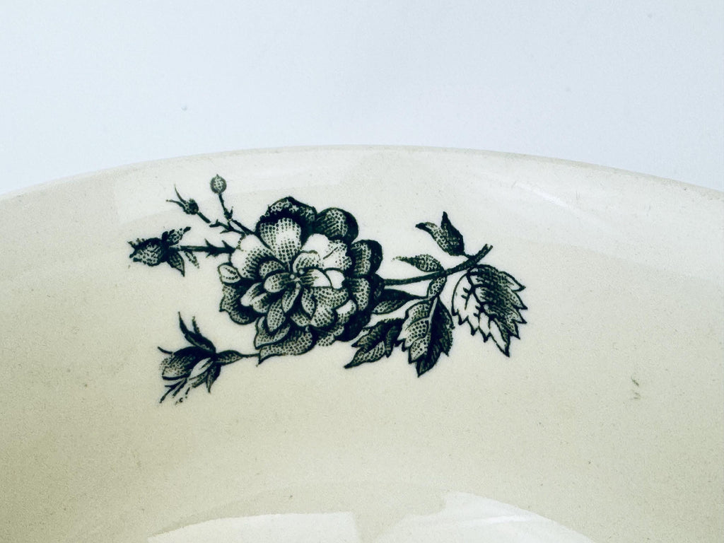 Decorative floral design on a white ceramic plate with a light gray background