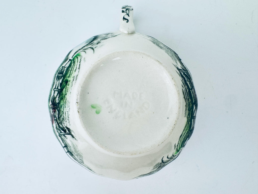 Ceramic plate with green floral patterns on a white background