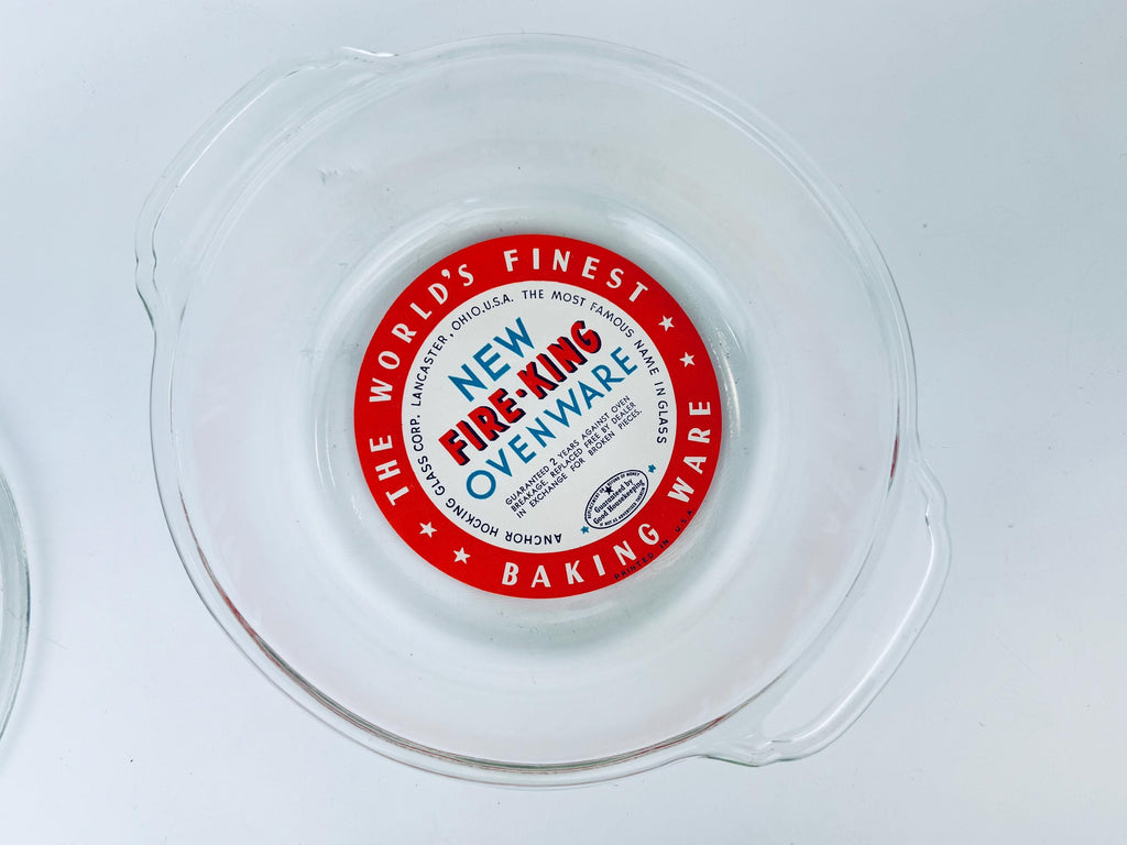 Red label on a clear plastic container with 'New Fire-King Ovenware' text.