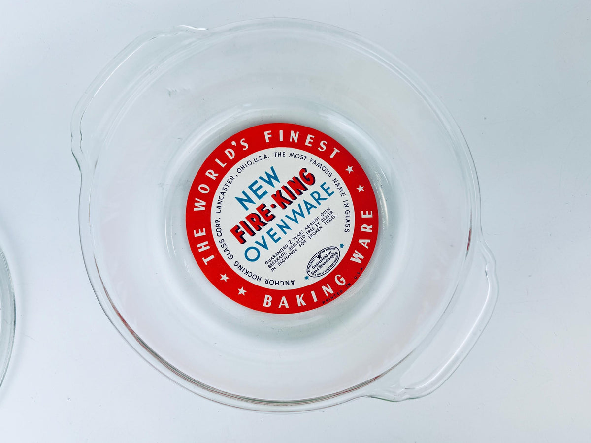 Red label on a clear plastic container with 'New Fire-King Ovenware' text.