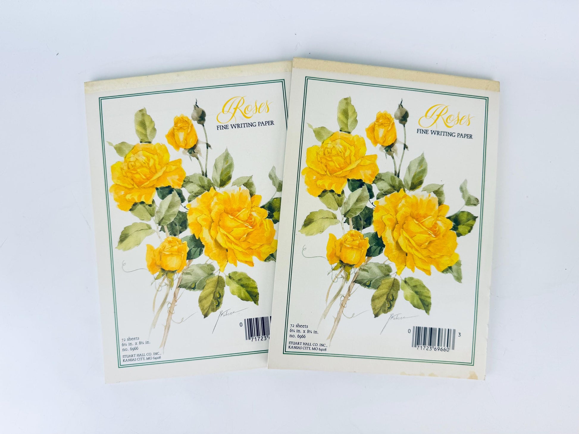 Two notebooks with yellow floral design on a white background