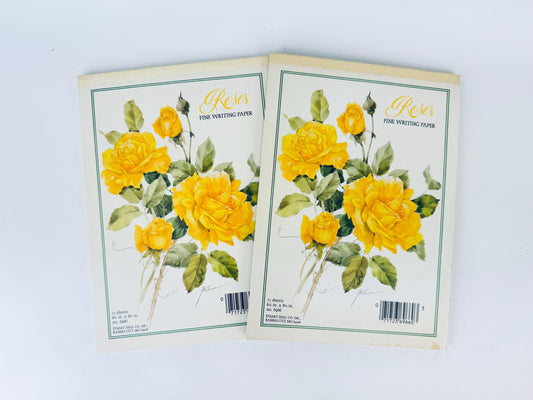 Two notebooks with yellow floral design on a white background