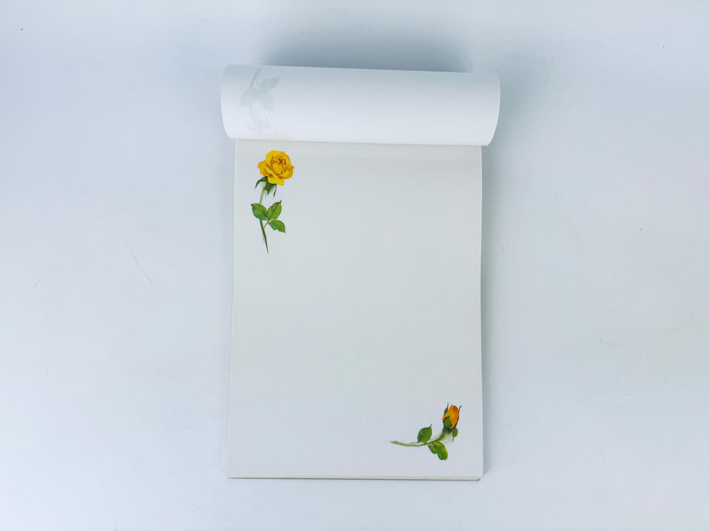 Notebook with a yellow rose design on a white background