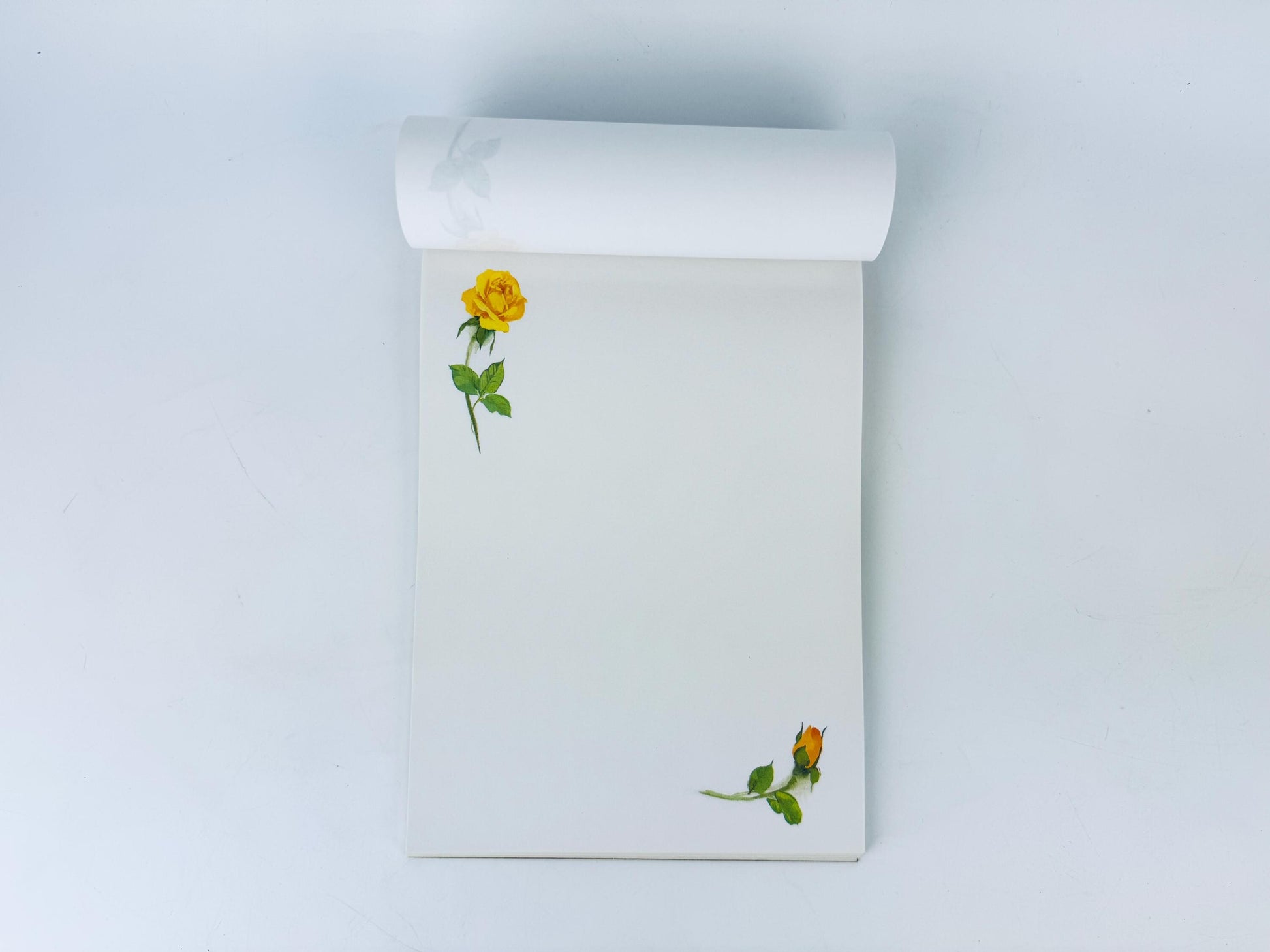 Notebook with a yellow rose design on a white background