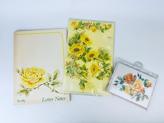 Set of floral letter pads and cards on a light gray background