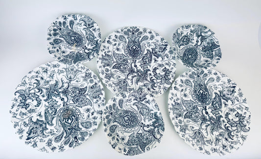 Set of six black and white patterned plates on a white background