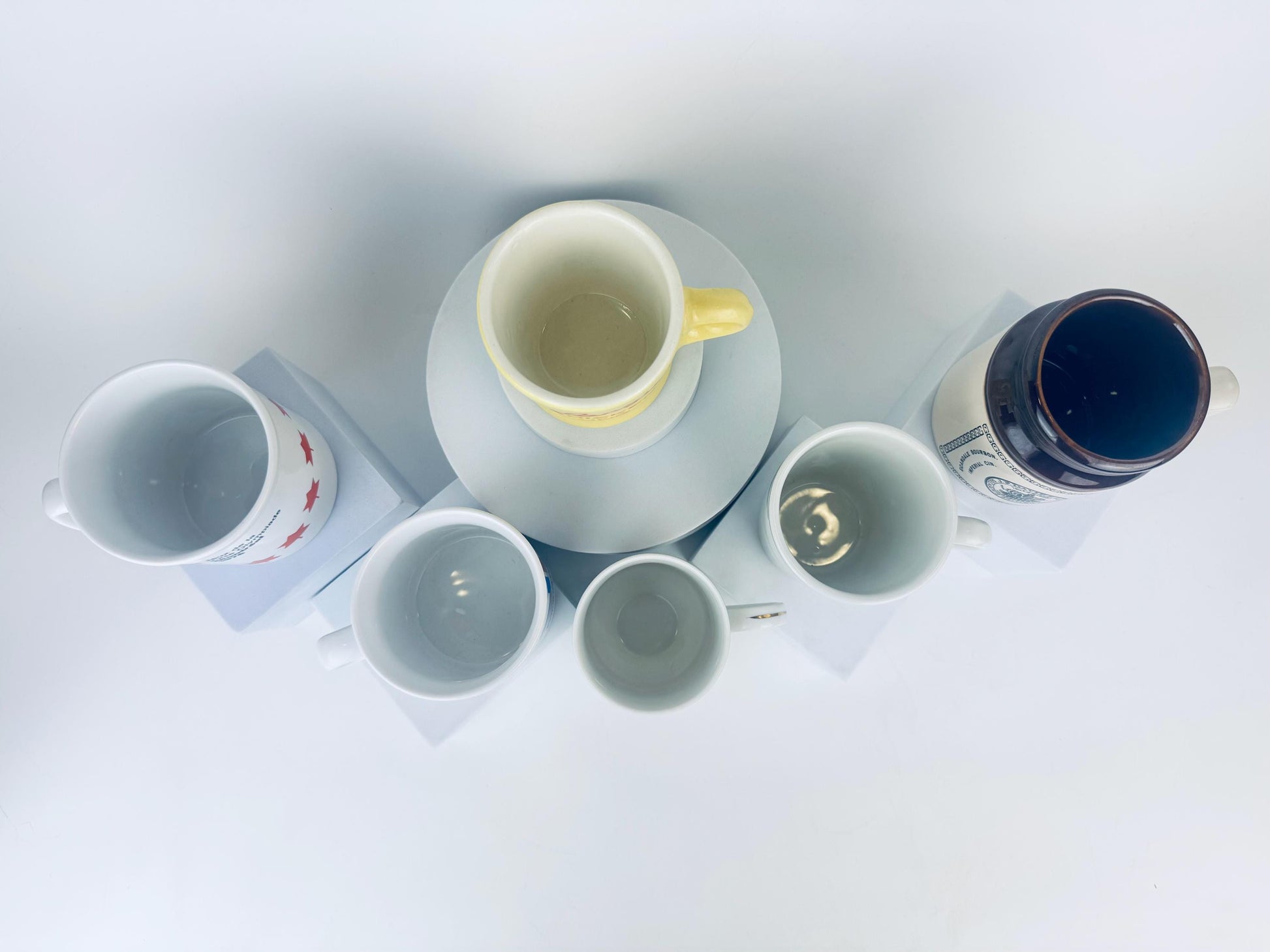 Collection of ceramic mugs on a white surface