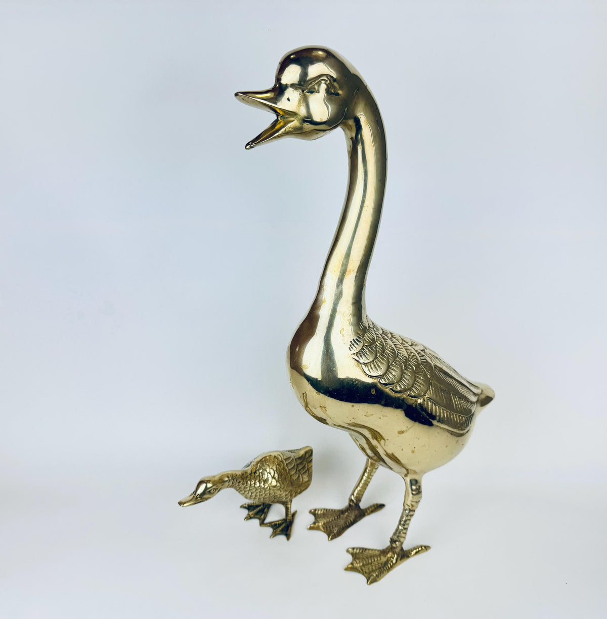 XL Gold duck and duckling figurines on a light gray background