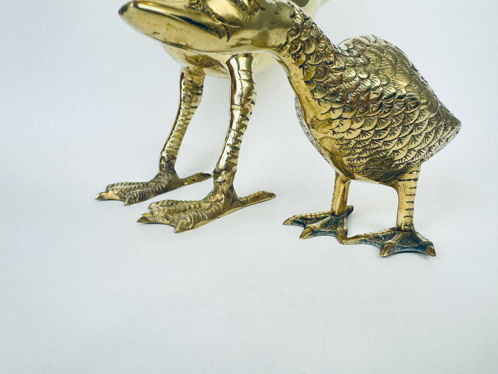 Brass duck figurine on a white background