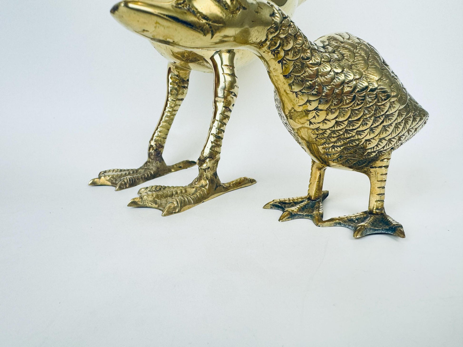 Brass duck figurine on a white background