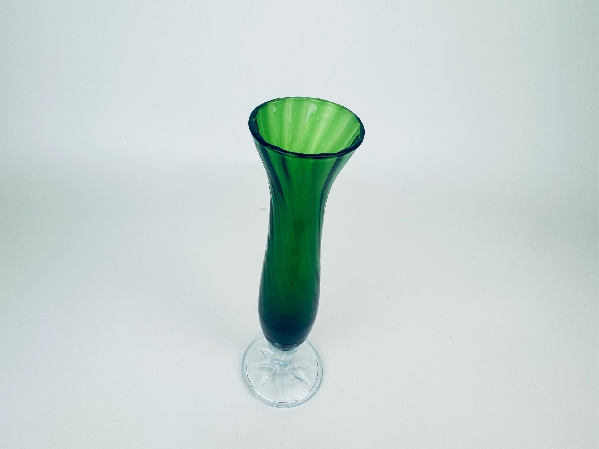 Green glass vase on a white background