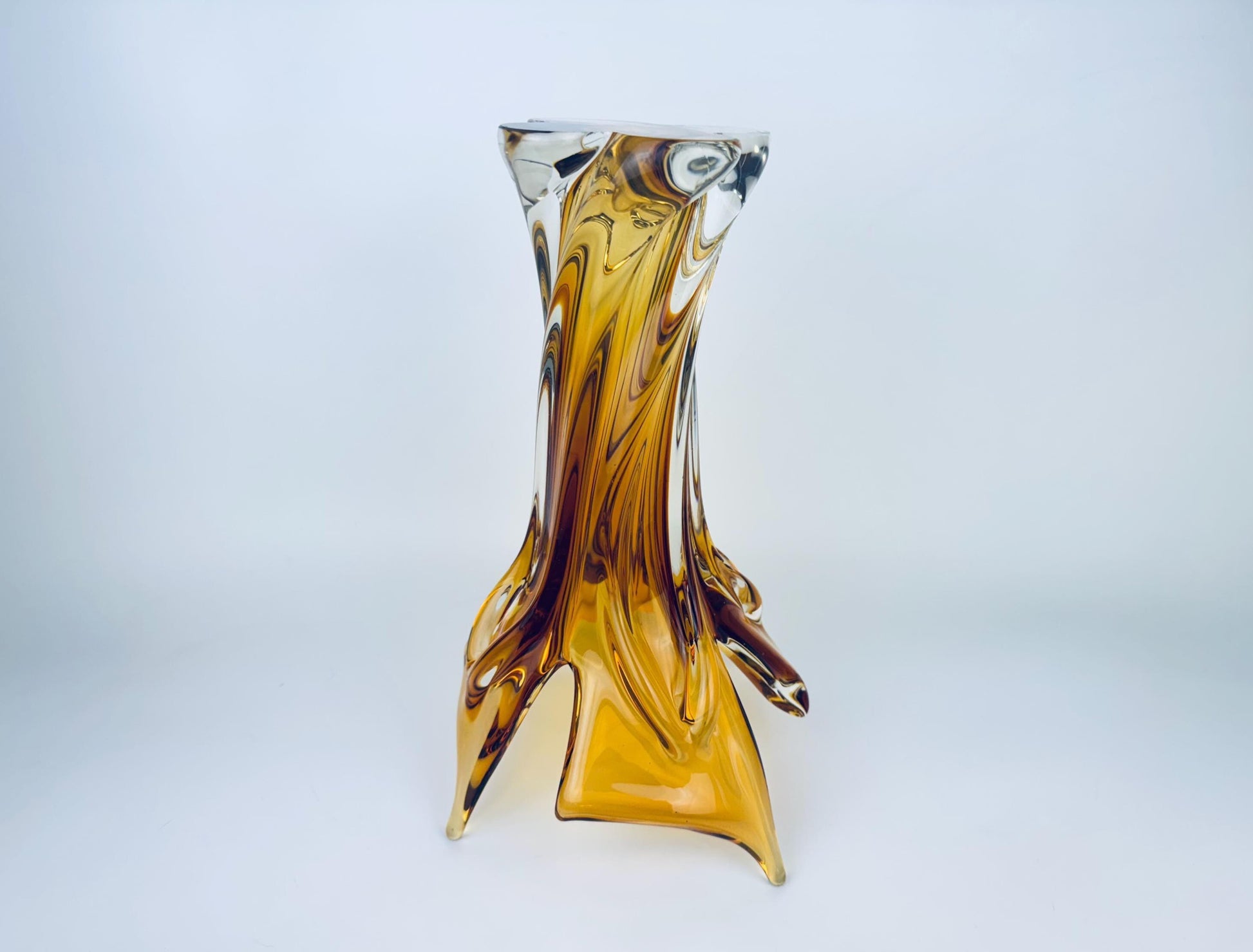 Glass vase with brown and clear design on a light gray background
