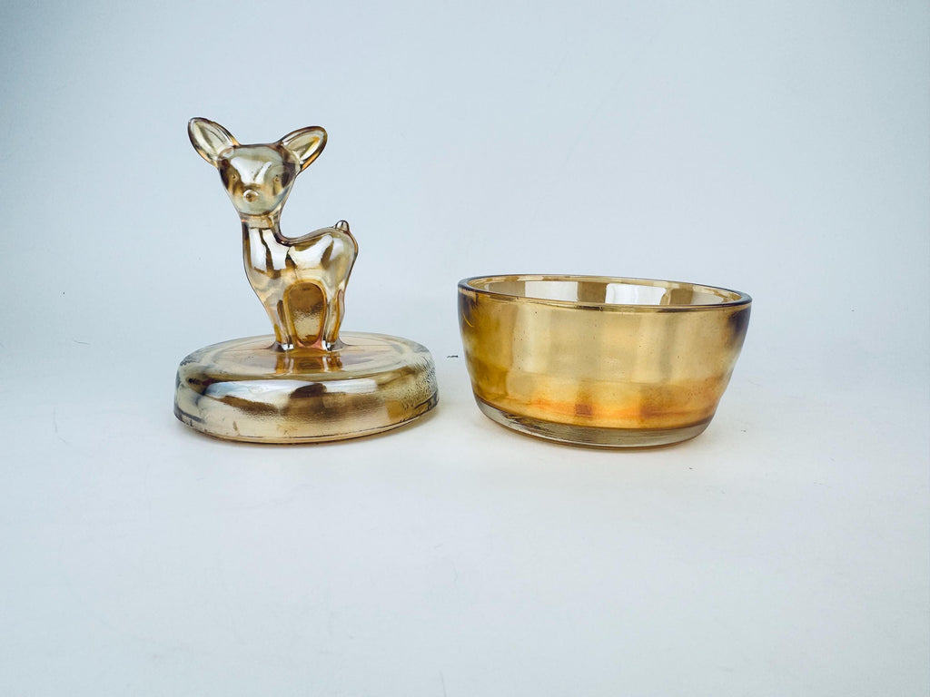 Two glass items, one shaped like a deer and the other a bowl, on a light gray background.