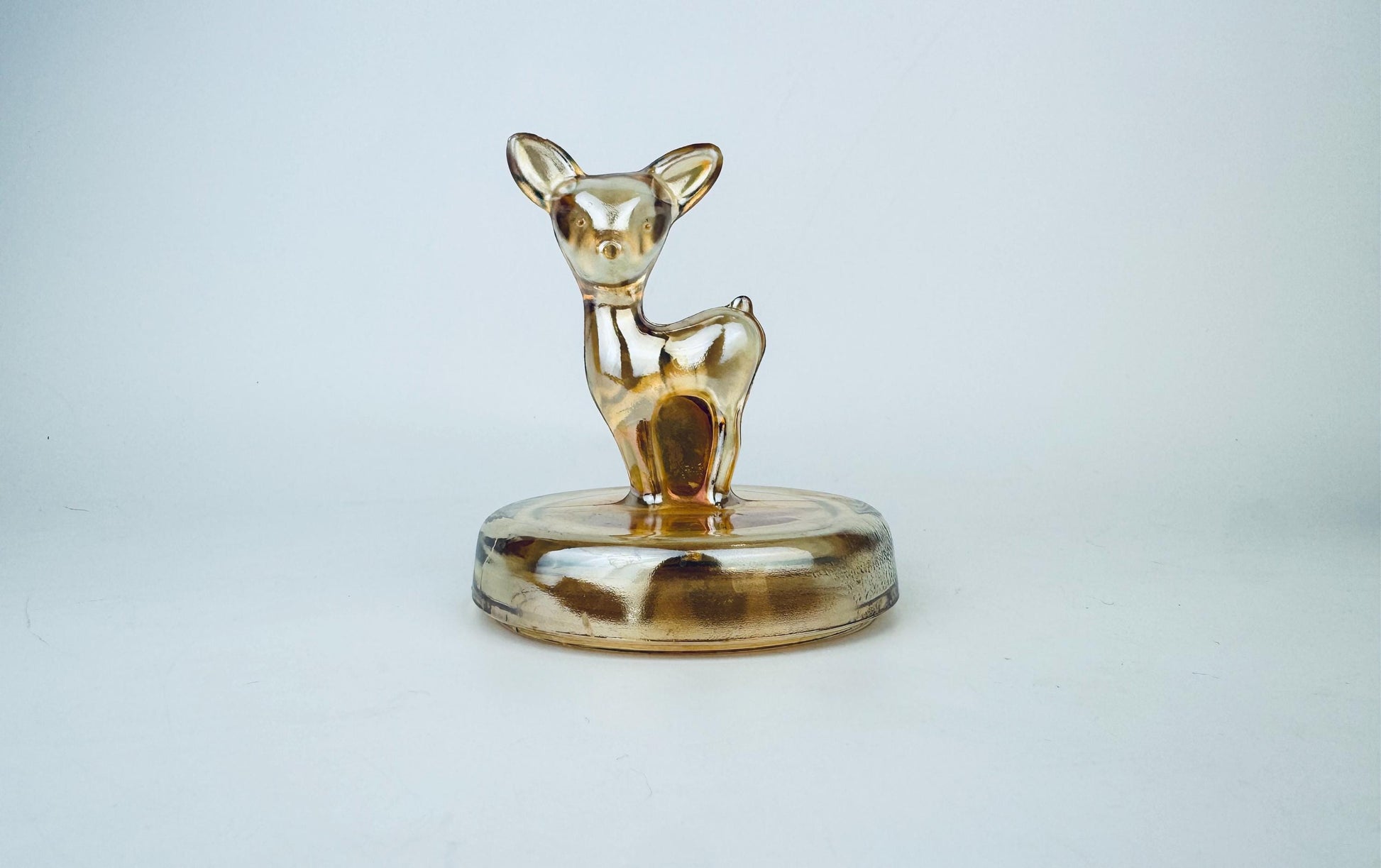 Glass deer figurine on a white background