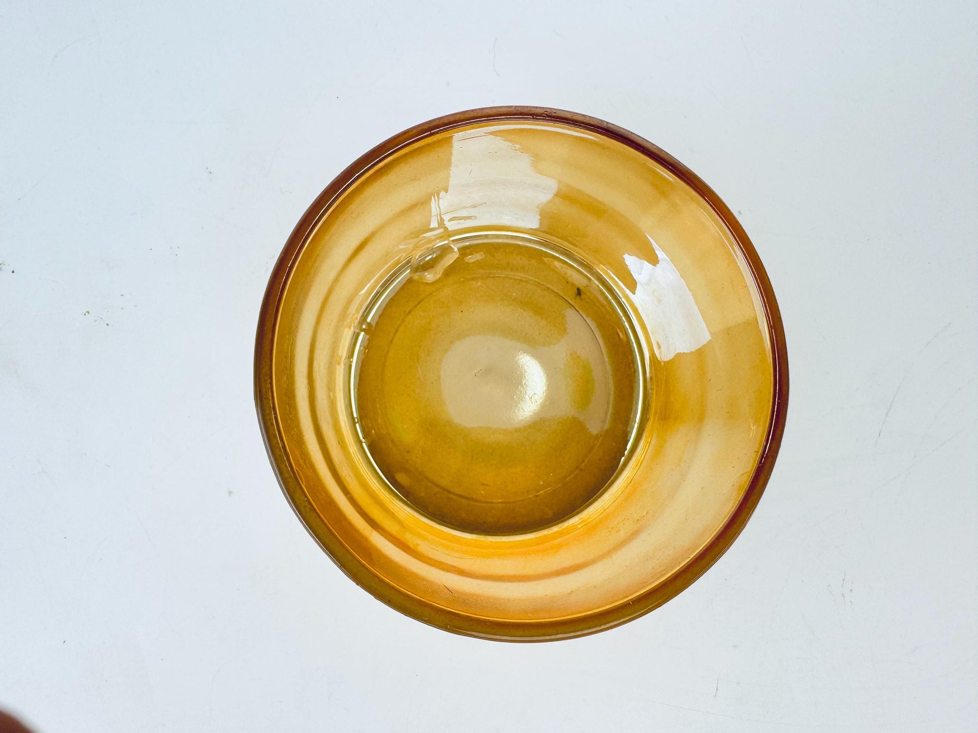Yellow glass bowl on a white background