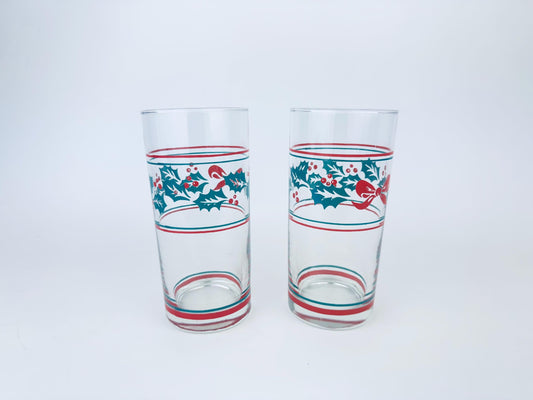 Two glass tumblers with festive designs on a white background