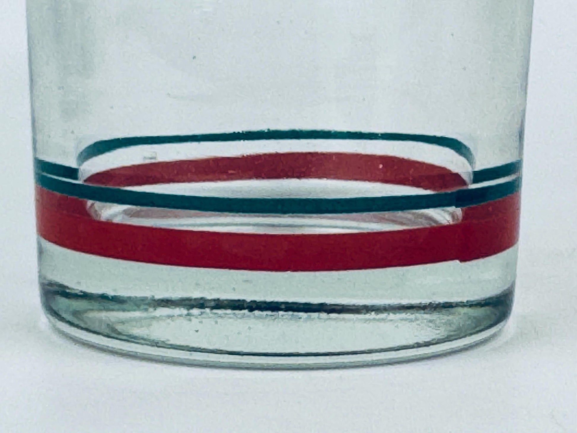 Clear glass with red and blue stripes on a white background