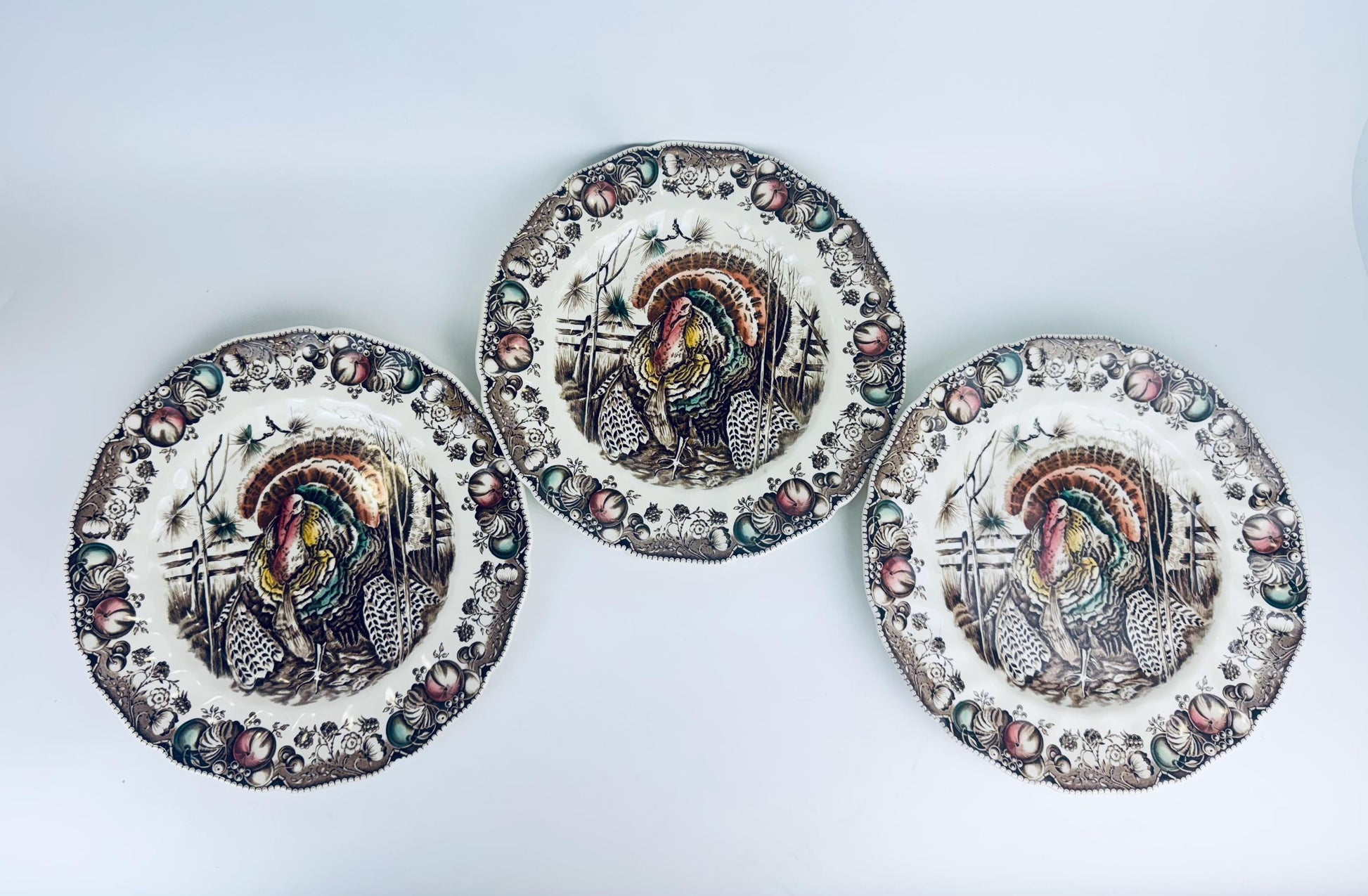 Three decorative plates with artistic designs on a white background