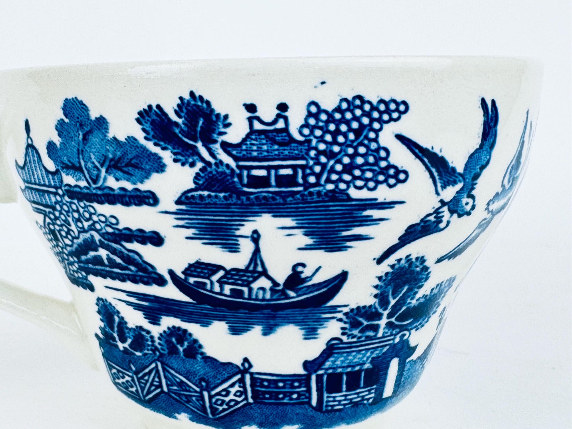 Ceramic bowl with blue floral and landscape design on a white background