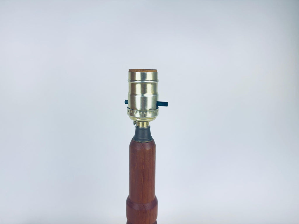Wooden lamp with metallic fitting on a white background