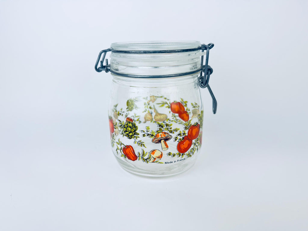 Glass jar with floral design on a white background