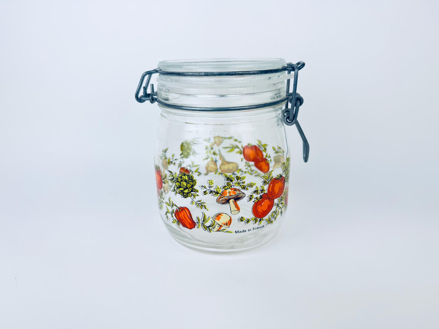 Glass jar with floral design on a white background