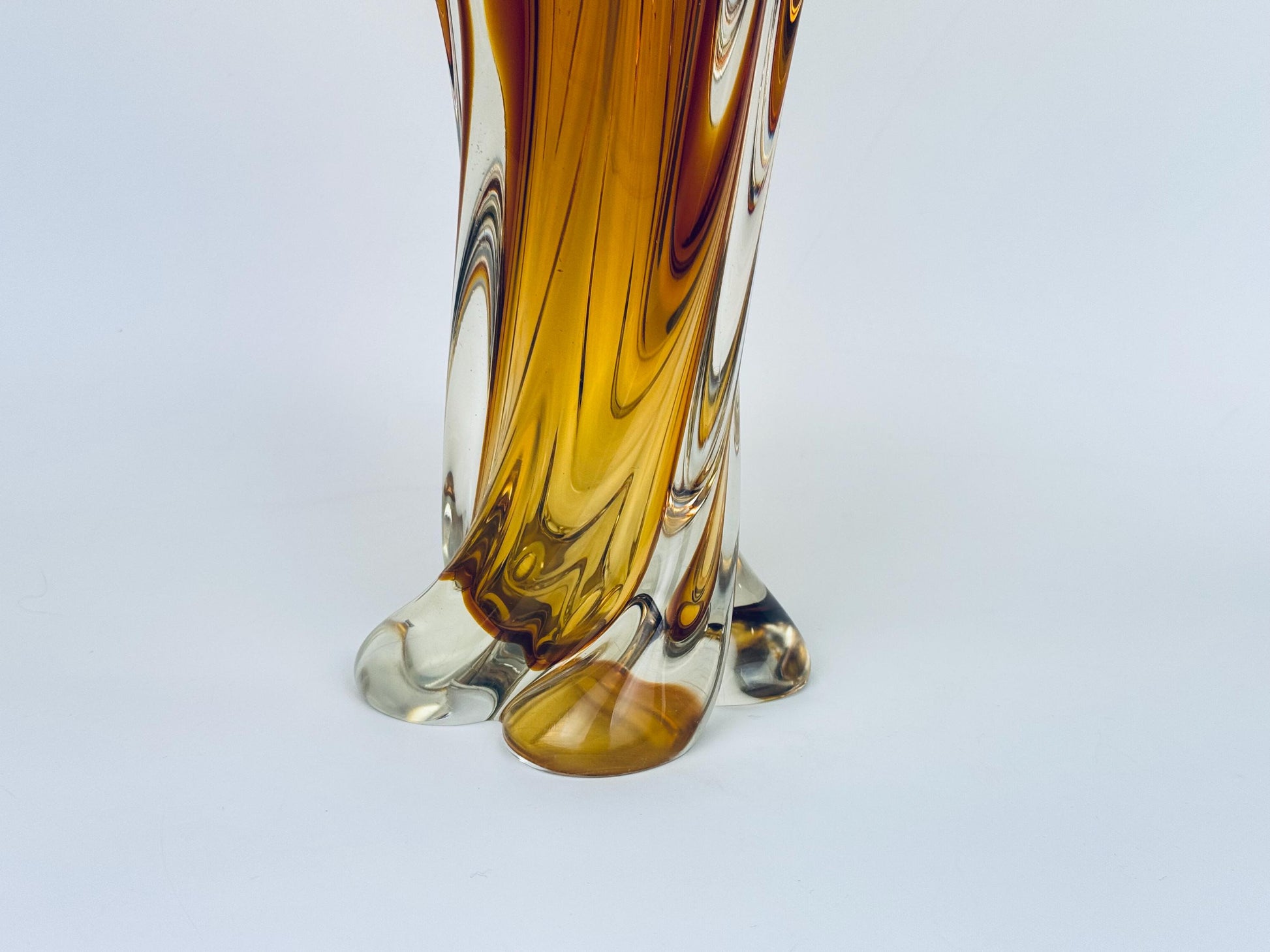 Glass vase with brown and clear swirl design on a white background