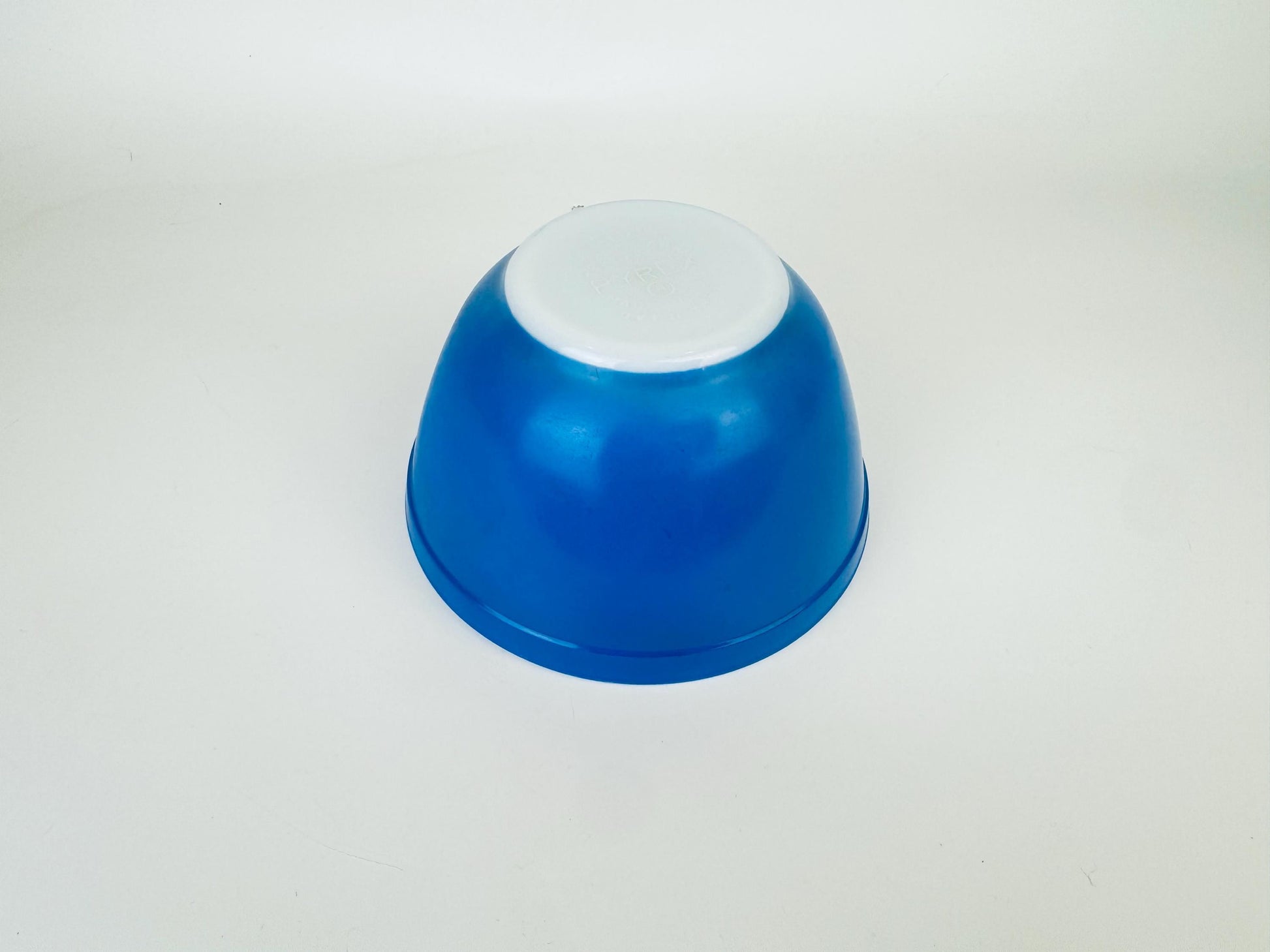 Blue and white glass bowl on a light gray background